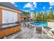 Backyard patio with hot tub, seating and pool with adjacent outdoor bar and kitchen area at 311 Kaitlyn Ln, Kings Mountain, NC 28086