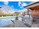 Outdoor kitchen with a built in grill next to the pool and outdoor seating area at 311 Kaitlyn Ln, Kings Mountain, NC 28086