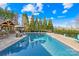 Inviting backyard pool area featuring lush landscaping and ample space for entertaining at 311 Kaitlyn Ln, Kings Mountain, NC 28086