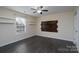 Bright bedroom featuring dark laminate floors and a wood accent wall at 3809 Carl Parmer Dr, Harrisburg, NC 28075