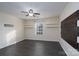 Spacious bedroom with dark laminate floors, ceiling fan, and window at 3809 Carl Parmer Dr, Harrisburg, NC 28075