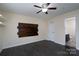 Bedroom with dark floors, ceiling fan, and access to bathroom at 3809 Carl Parmer Dr, Harrisburg, NC 28075