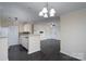 Open kitchen with white cabinets and a breakfast bar at 3809 Carl Parmer Dr, Harrisburg, NC 28075