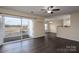 Living room with dark floors and access to a balcony at 3809 Carl Parmer Dr, Harrisburg, NC 28075