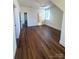 Spacious bedroom with dark hardwood floors and natural light from a window at 421 Delburg Mill Alley Dr, Davidson, NC 28036