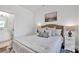 Cozy bedroom with soft bedding, white nightstands, and a serene painting for a relaxing retreat at 421 Delburg Mill Alley Dr, Davidson, NC 28036