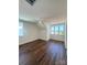 Upstairs bedroom with hardwood floors, natural lighting, and an ensuite bathroom at 421 Delburg Mill Alley Dr, Davidson, NC 28036