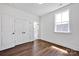 Bright bedroom with natural light, wood floors, a double door closet, and white trim at 421 Delburg Mill Alley Dr, Davidson, NC 28036