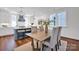 Open-concept dining room with modern lighting, hardwood floors, and neutral décor at 421 Delburg Mill Alley Dr, Davidson, NC 28036