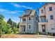 Charming two-story blue home with a front porch, landscaped yard, and mature trees at 421 Delburg Mill Alley Dr, Davidson, NC 28036