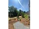 A neatly landscaped front yard features lush greenery and mulch under a clear sky at 421 Delburg Mill Alley Dr, Davidson, NC 28036