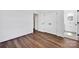 Hallway with wood floors, closet, and view into a bathroom with a sink and mirror at 421 Delburg Mill Alley Dr, Davidson, NC 28036