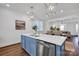 Kitchen island with a sink, stainless steel dishwasher, and modern pendant lighting at 421 Delburg Mill Alley Dr, Davidson, NC 28036