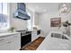 Stylish kitchen with white cabinets, stainless steel appliances, and a modern vent hood at 421 Delburg Mill Alley Dr, Davidson, NC 28036