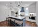 Bright kitchen featuring an island with seating, modern appliances, and pendant lights at 421 Delburg Mill Alley Dr, Davidson, NC 28036