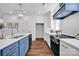 Open kitchen with a center island, stainless steel appliances, and modern lighting at 421 Delburg Mill Alley Dr, Davidson, NC 28036