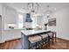 Modern kitchen with white cabinets, a blue island, quartz countertops and pendant lighting at 421 Delburg Mill Alley Dr, Davidson, NC 28036