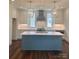 Modern kitchen with a large island, white cabinets, and stainless steel appliances at 421 Delburg Mill Alley Dr, Davidson, NC 28036