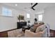 Cozy living room with dark hardwood floors, neutral walls, decorative furniture, and lots of natural light at 421 Delburg Mill Alley Dr, Davidson, NC 28036