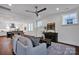 Open-concept living room with hardwood floors, bright lighting, and views into the adjacent dining and kitchen areas at 421 Delburg Mill Alley Dr, Davidson, NC 28036