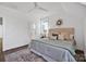 Well-lit main bedroom with hardwood floors, light walls, ceiling fan, and an adjacent bathroom at 421 Delburg Mill Alley Dr, Davidson, NC 28036