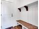 Mudroom featuring a wooden bench, hooks, and white wainscoting near the entrance at 421 Delburg Mill Alley Dr, Davidson, NC 28036