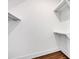 Simple walk-in closet with hardwood floors and minimal shelving, offering versatile storage options at 421 Delburg Mill Alley Dr, Davidson, NC 28036