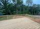 New backyard wooden deck surrounded by lush greenery, perfect for outdoor entertaining and relaxation at 426 Richards Ln, Mooresville, NC 28115