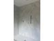 Elegant bathroom with marble-patterned tile walls, built-in shelving, and a sleek, curbless shower design at 426 Richards Ln, Mooresville, NC 28115