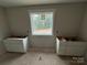An unfinished bathroom featuring a window overlooking trees and under-mounted sink cabinets at 426 Richards Ln, Mooresville, NC 28115