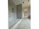 Elegant bathroom with marble-patterned tile walls, built-in shelving, and a sleek, curbless shower design at 426 Richards Ln, Mooresville, NC 28115