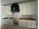A kitchen under construction featuring white cabinets, drawers, and a black vent hood at 426 Richards Ln, Mooresville, NC 28115