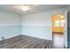 Bedroom featuring wood-look floors, modern ceiling fan fixture, and view to an adjoining room at 4926 Nc Highway 109 South, Mount Gilead, NC 27306