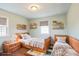 Charming bedroom featuring twin beds, shelving and light green walls at 4926 Nc Highway 109 South, Mount Gilead, NC 27306