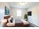 Comfortable bedroom featuring a queen bed with a tufted headboard and a mounted TV at 4926 Nc Highway 109 South, Mount Gilead, NC 27306