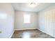 Bedroom featuring wood-look floors, an access door, and a double-door closet at 4926 Nc Highway 109 South, Mount Gilead, NC 27306