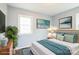 Bedroom features hardwood floors, a queen bed, neutral paint, and windows for natural light at 4926 Nc Highway 109 South, Mount Gilead, NC 27306