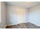 Bedroom featuring wood-look floors, an access door, and a double-door closet at 4926 Nc Highway 109 South, Mount Gilead, NC 27306