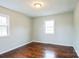 Empty bedroom features hardwood floors, two windows for natural light, and neutral paint at 4926 Nc Highway 109 South, Mount Gilead, NC 27306
