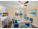 The dining room is virtually staged with blue chairs, table settings and decor at 4926 Nc Highway 109 South, Mount Gilead, NC 27306