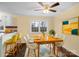 Bright dining room is virtually staged with bright yellow chairs and modern art at 4926 Nc Highway 109 South, Mount Gilead, NC 27306