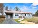 Cozy home featuring light blue siding, a red roof, a carport, and a welcoming front entrance at 4926 Nc Highway 109 South, Mount Gilead, NC 27306