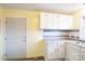 This kitchen features white cabinets, modern appliances, and a stylish backsplash, creating a functional cooking space at 4926 Nc Highway 109 South, Mount Gilead, NC 27306