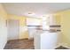 An open kitchen with white cabinetry and a breakfast bar offers ample space for cooking and entertaining at 4926 Nc Highway 109 South, Mount Gilead, NC 27306