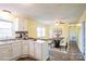 Bright kitchen and dining area with white cabinets, a dining table, and hardwood floors at 4926 Nc Highway 109 South, Mount Gilead, NC 27306