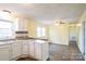 Bright kitchen and dining area with white cabinets, modern appliances, and hardwood floors at 4926 Nc Highway 109 South, Mount Gilead, NC 27306