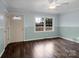 Bright living room with wood-look floors, large windows, and two entry doors at 4926 Nc Highway 109 South, Mount Gilead, NC 27306
