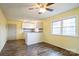 Open-concept living room with hardwood floors and a large window, providing ample natural light and a view to the outside at 4926 Nc Highway 109 South, Mount Gilead, NC 27306