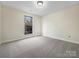 Simple bedroom with large window and grey carpet at 500 Kirby Ln, Matthews, NC 28104