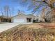 Ranch style home with attached two-car garage and landscaped yard at 500 Kirby Ln, Matthews, NC 28104